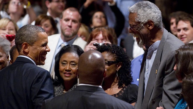 President Barack Obama greets NBA legend Bill Russell after speaking during a Democratic National Committee event at the Adrienne Arsht Center in Miami, Florida, June 13, 2011.