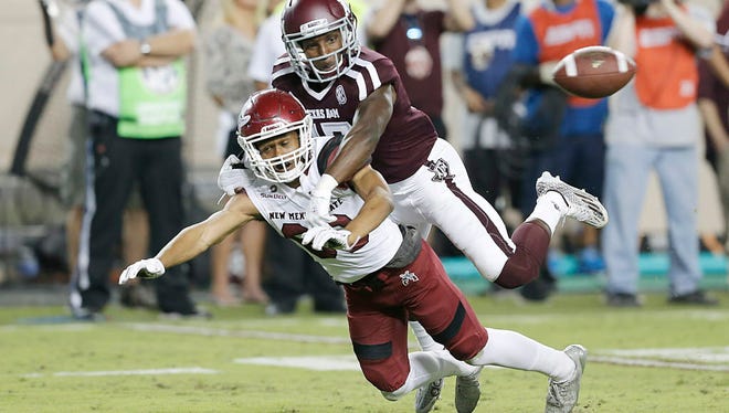 Texas A&M defensive back Alex Sezer (17) is called for pass interference against New Mexico State wide receiver Anthony Muse (80).