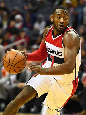 John Wall (2) dribbles the ball against the Milwaukee Bucks during the second half at Verizon Center.