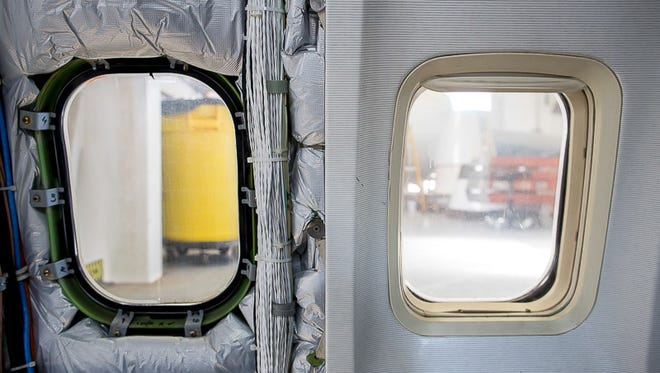 Many typically standard passenger features are missing from inside Honeywell's Boeing 757 test bed, such as window and wall covers.