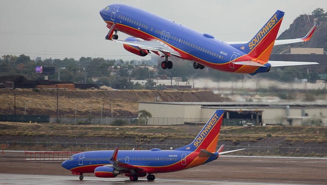 Southwest jets trade places at a rainy Phoenix Sky Harbor International Airport on Jan. 31, 2015.