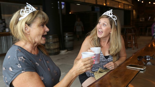 Patti Maynard (right) and her mother Kelli Belt, both from Pewaukee enjoy a beer at the Budweiser Pavilion. The two were awarded their crowns for ordering the very first beer of the fair at the Budweiser Pavilion.