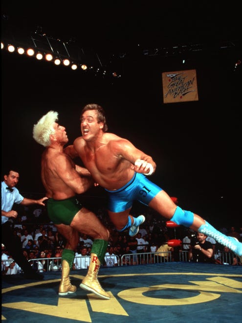 Kevin Greene, right, flies at Ric Flair in this WCW photo.