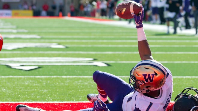 Washington Huskies wide receiver John Ross (1) reacts to scoring a touchdown during the first half against the Utah Utes at Rice-Eccles Stadium.