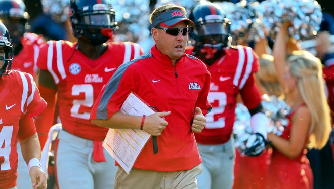 Mississippi Rebels head coach Hugh Freeze leads the team to the field before the game against the Southeast Missouri State Redhawks at Vaught-Hemingway Stadium.