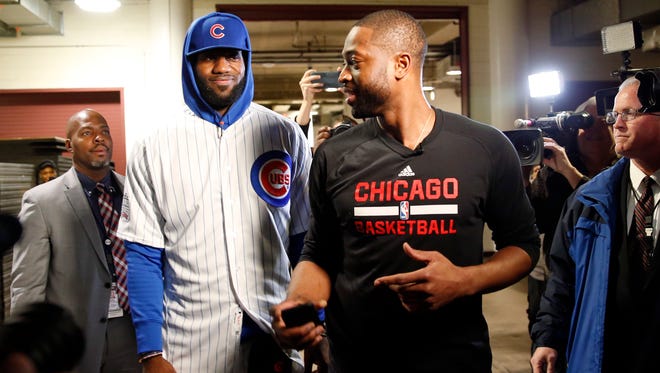 LeBron James (in full Cubs uniform) talks with Dwyane Wade before their game on Friday, Dec. 2, 2016, in Chicago.