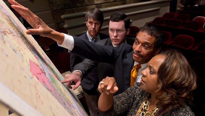 Alabama lawmakers study a map of the proposed redistricting plan crafted by the Republican state Legislature in 2012.