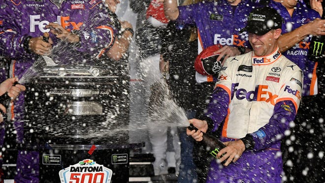 Denny Hamlin celebrates after winning the 61st annual Daytona 500 at Daytona International Speedway.