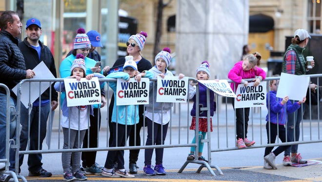 Young fans wait for the start of the World Series victory parade on Michigan Avenue.