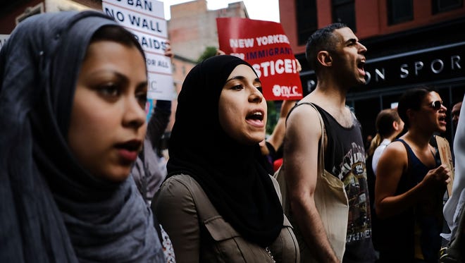Recent Immingrants join activists for an evening protest in Manhattan hours before a revised version of President Donald Trump's travel ban that was approved by the Supreme Court is to take effect on June 29, 2017 in New York.