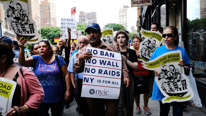 Recent Immingrants join activists for an evening protest in Manhattan.