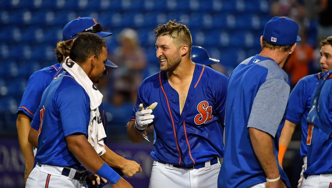 July 13: Tim Tebow is mobbed by teammates after hitting a walk off solo home run.