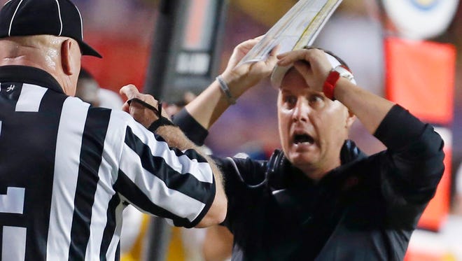 Mississippi head coach Hugh Freeze challenges an official in the first half of an NCAA college football game against LSU in Baton Rouge, La., Saturday, Oct. 25, 2014.