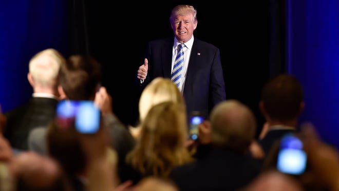 GOP presidential nominee Donald Trump walks on stage and gives a thumbs up to the audience as he enters at Eisenhower Hotel in Gettysburg just after noon on Saturday, Oct. 22, 2016.