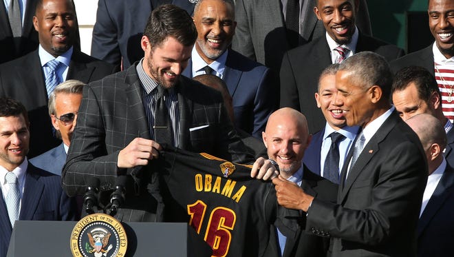 Kevin Love presents President Obama with a personalized Cavs jersey.