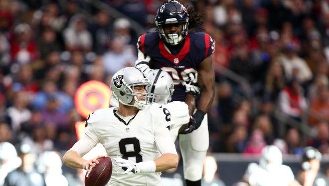 Oakland Raiders quarterback Connor Cook (8) drops back to pass during the first quarter of the AFC Wild Card playoff football game against the Houston Texans at NRG Stadium.