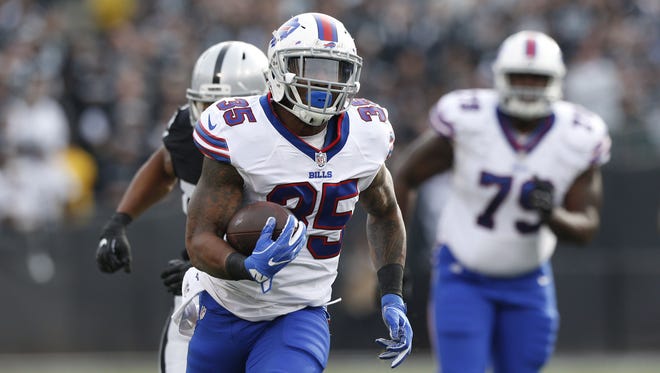 Buffalo Bills running back Mike Gillislee (35) runs for a first down against the Oakland Raiders in the first quarter at Oakland Coliseum.
