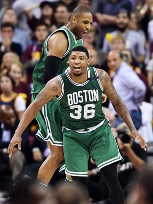 Boston Celtics guard Marcus Smart (36) and center Al Horford (42) celebrate after the Celtics beat the Cleveland Cavaliers in Game 3 of the Eastern Conference finals.