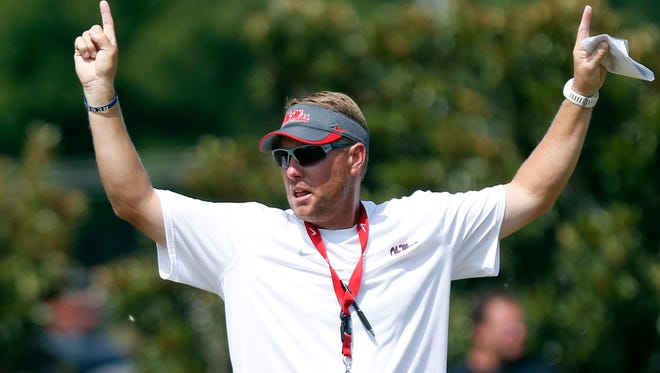 Mississippi football coach Hugh Freeze gives the touchdown signal after an offensive play successful ended in the end zone during practice in Oxford, Miss., Friday, Aug. 9, 2013.  (AP Photo/Rogelio V. Solis)