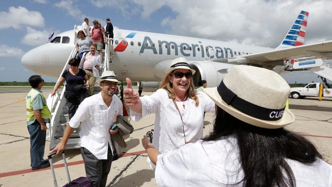 American Airlines executives Gabriel Crespo (left) and Lina Santiago, a greet Christine Valls, an American Airlines sales director,  who arrived in Cienfuegos, Cuba, on American Airlines inaugural scheduled service from Miami on Sept. 7, 2016.