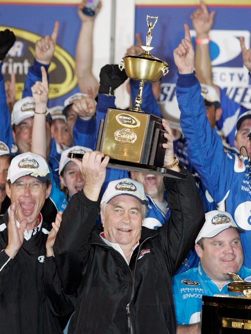 Roger Penske holds a trophy after his driver, Ryan Newman, won the Daytona 500 on Feb. 17, 2008.