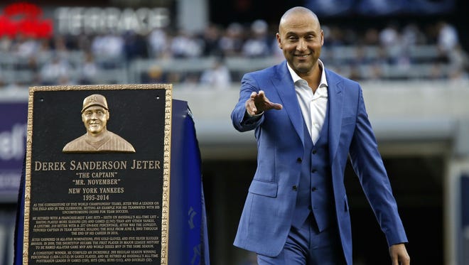 Derek Jeter gestures to his Yankee family during his jersey retirement ceremony Sunday.