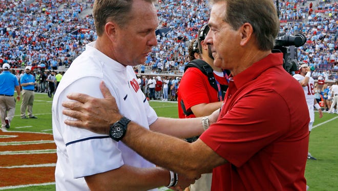 Mississippi head coach Hugh Freeze, left, and Alabama head coach Nick Saban shake hands before an NCAA college football game, Saturday, Sept. 17, 2016 in Oxford, Miss. (AP Photo/Rogelio V. Solis)