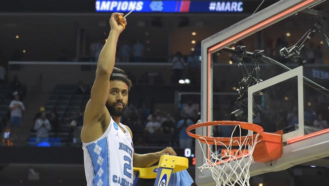 North Carolina Tar Heels guard Joel Berry II (2) helps to cut the nets after defeating the Kentucky Wildcats in the finals of the South Regional of the 2017 NCAA Tournament at FedExForum. North Carolina won 75-73.