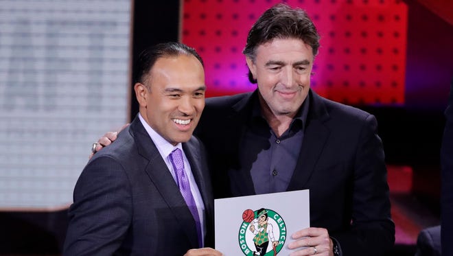 NBA Deputy Commissioner Mark Tatum, left, poses for photographs with Boston Celtics co-owner Wyc Grousbeck, right, after the Celtics won the first pick in the NBA draft.