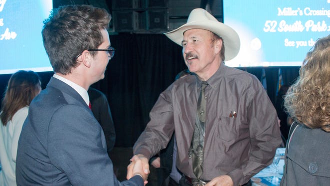 In this March 18, 2017, file photo, congressional candidate Rob Quist meets with supporters during the annual Mansfield Metcalf Celebration dinner hosted by the state's Democratic Party in Helena, Mont.
