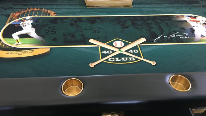 A poker table in Jose Canseco's Las Vegas home celebrates his 40-home run, 40-stolen base season in 1988.