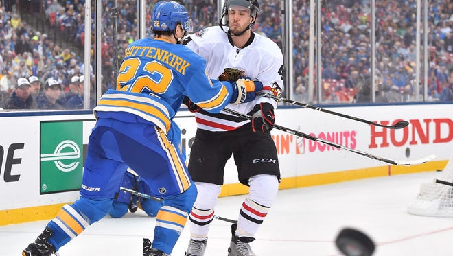 Chicago Blackhawks defenseman Niklas Hjalmarsson (4) battles for the puck with St. Louis Blues defenseman Kevin Shattenkirk (22) during the second period in the 2016 Winter Classic.