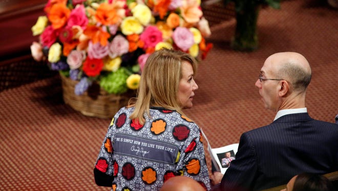 A woman wears a shirt inspired by Craig Sager as she talks with NBA commissioner Adam Silver before the start of the memorial service for broadcaster Craig Sager at Mount Bethel United Methodist Church.