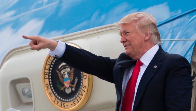 President Trump points to supporters as he walks off Air Force One in Atlanta on April 28, 2017.