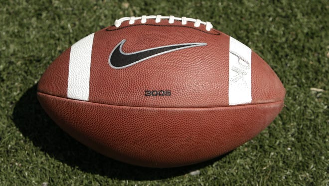 A football used by Georgia Tech rests on the field before the school's spring game.