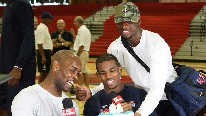 2008: Dwyane Wade gives Gary Payton a cake for his 40th birthday as he interviews Wade's teammate Chris Paul.