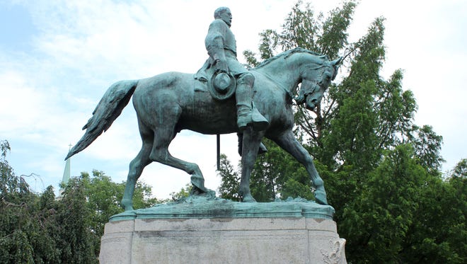 The faint outlines of the phrase "Black Lives Matter" remain on the statue of Robert  E. Lee after it was vandalized at Lee Park in Charlottesville, Va., in this June 30, 2015 photo.