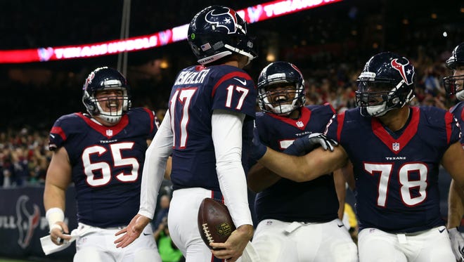 Houston Texans quarterback Brock Osweiler (17) celebrates with teammates after running the ball in for a touchdown during the fourth quarter of the AFC Wild Card playoff football game against the Oakland Raiders at NRG Stadium.