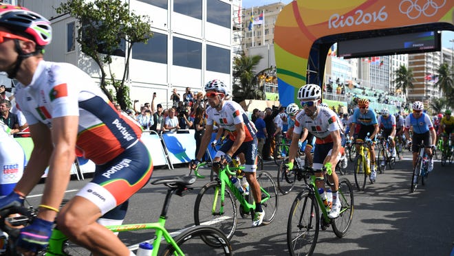 Cyclists leave the start line during the men's road race in the Rio 2016 Summer Olympic Games at Fort Copacabana.