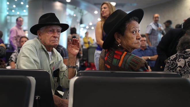 Joaquin Ayella (left) and Laudelina Terrero wait to board American Airlines Flight 903 to Cuba in Miami on Sept. 7, 2016.