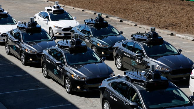 A group of self driving Uber vehicles position themselves to take journalists on rides during a media preview at Uber's Advanced Technologies Center in Pittsburgh