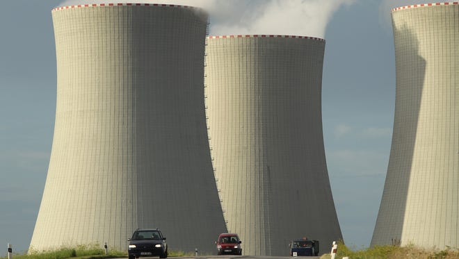 Cars drive by the four cooling towers of the Temelin nuclear power plant on August 11, 2011 near Temelin, Czech Republic.