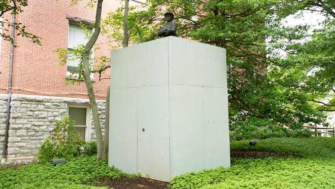 A statue of a Confederate cavalryman stands next to the Old Brick Courthouse in Rockville, Md. The memorial to southern soldiers from Montgomery county has been encased in a wooden box after vandals spray-painted graffiti on the 16 foot tall statue.