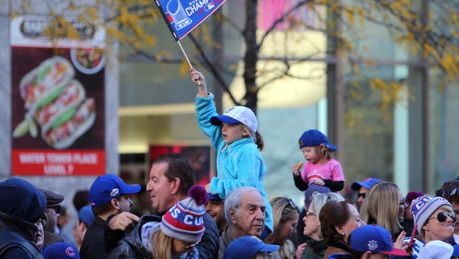 A young girl waves a pennant on Michigan Avenue.