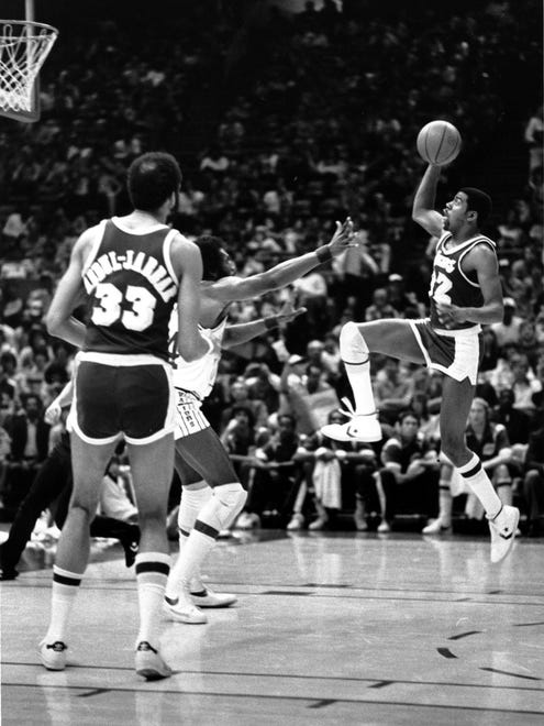 1980: Earvin "Magic" Johnson (32) of the Los Angeles Lakers starts his glide far from the basket as he makes a layup during the first half of the game with the Golden State Warriors.