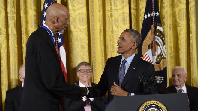 President Barack Obama shakes hands with NBA legend Kareem Abdul-Jabbar shortly before presenting him with the Presidential Medal of Freedom, the nation's highest civilian honor, during a ceremony honoring 21 recipients, in the East Room of the White House in Washington, DC, Nov. 22, 2016.