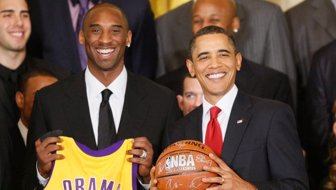 President Barack Obama stands with Los Angeles Lakers guard Kobe Bryant in the East Room of the White House in Washington, Monday, Jan. 25, 2010.