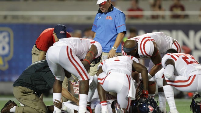 ORLANDO, FL - SEPTEMBER 05:  Head coach Hugh Freeze of the Mississippi Rebels looks on as Ken Webster #5 is tended to by medical staff in the first half against the Florida State Seminoles during the Camping World Kickoff at Camping World Stadium on September 5, 2016 in Orlando, Florida.  (Photo by Streeter Lecka/Getty Images)