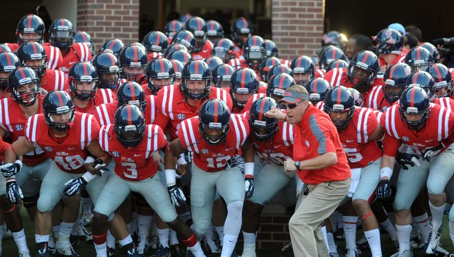 Mississippi coach Hugh Freeze leads the team onto the field at Vaught-Hemingway Stadium for an NCAA college football game against Southeast Missouri State in Oxford, Miss., Saturday, Sept. 7, 2013.