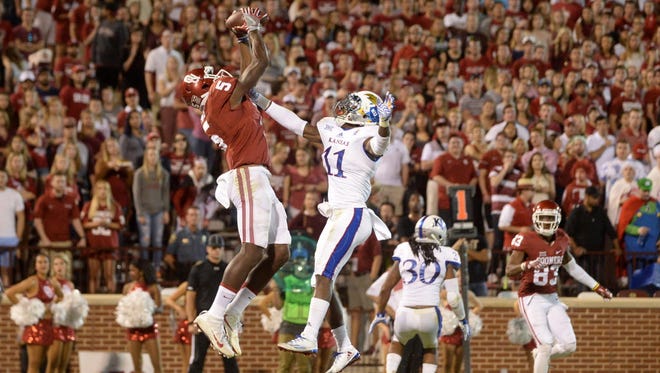 Oklahoma wide receiver Geno Lewis (5) catches a touchdown pass during the third quarter against Kansas.